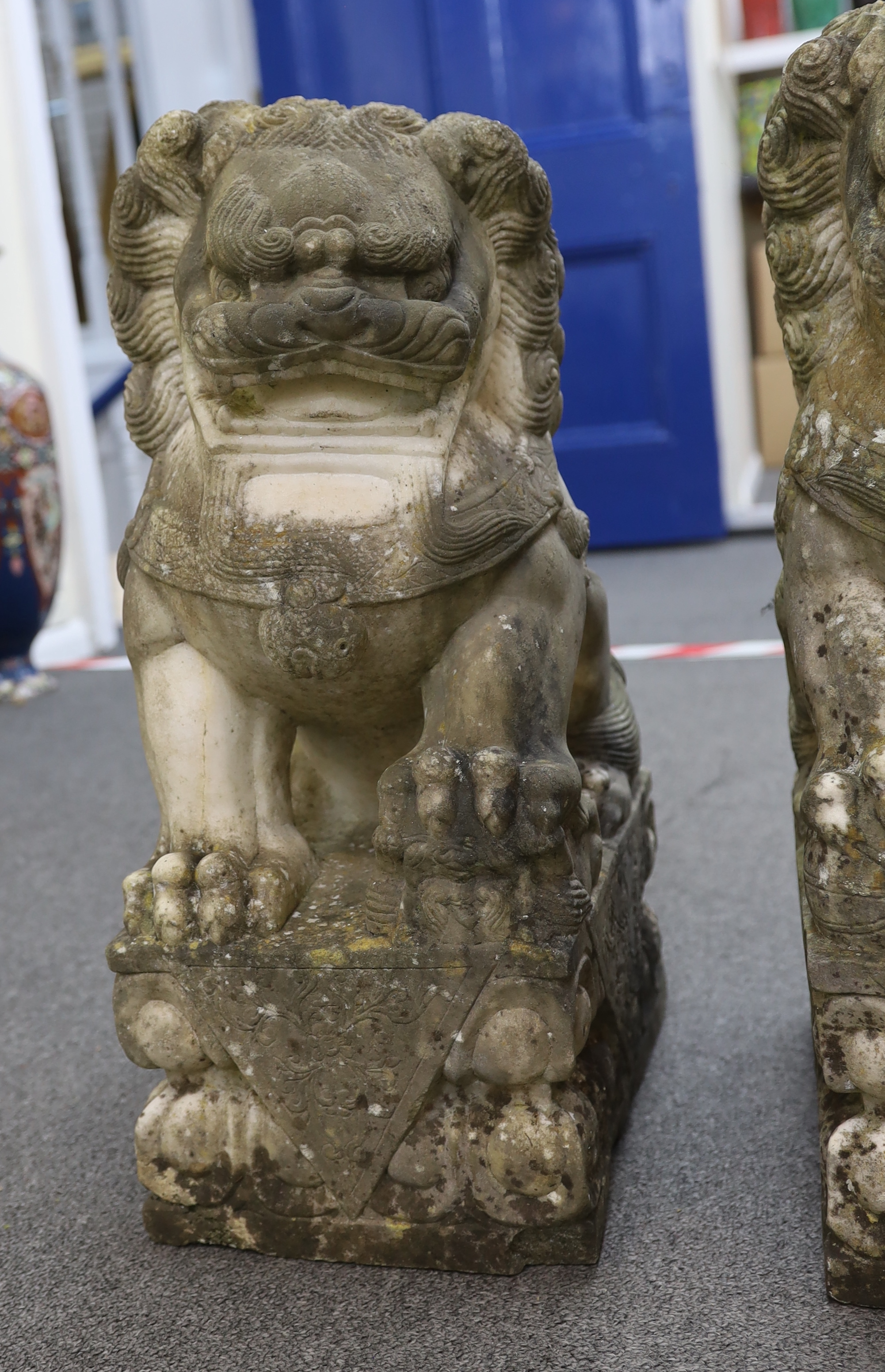 A pair of 20th century Chinese carved marble garden statues modelled as Dogs of Fo, each with weathered finish, 22cm wide, 31cm deep, 54cm high